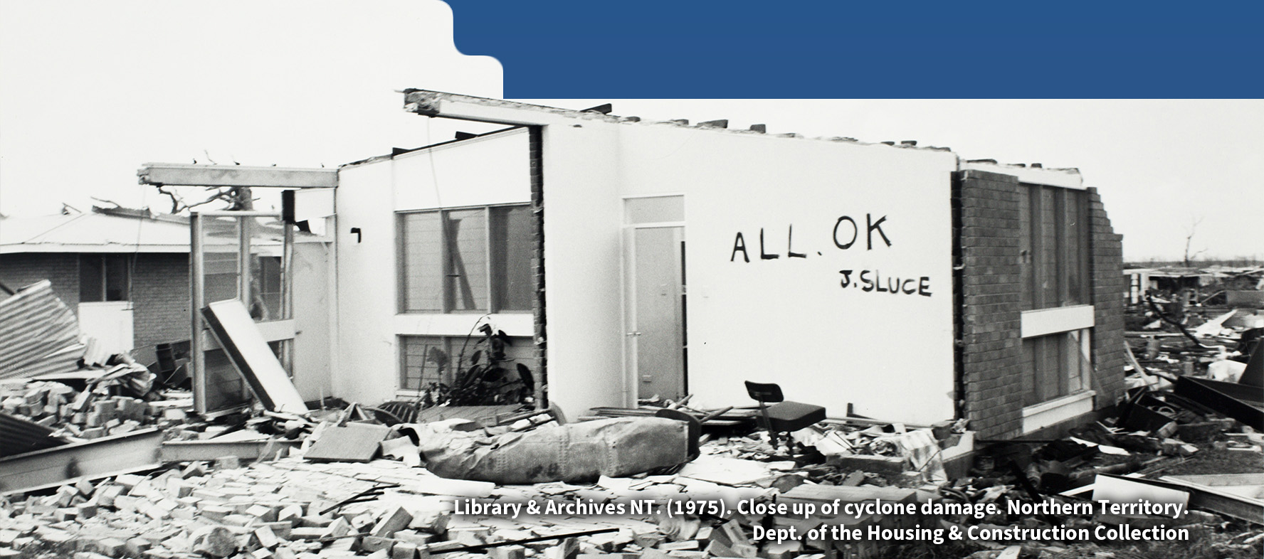 Photo showing extensive destruction in Darwin caused by Cyclone Tracy, with buildings was written ALL OK 